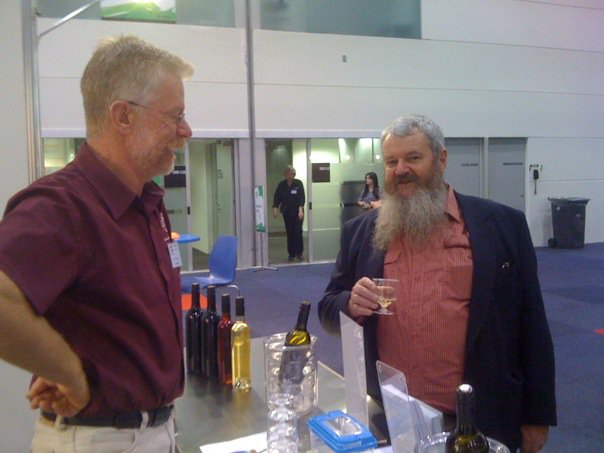 Darby doing research and making contacts at a wine show. Cheers!