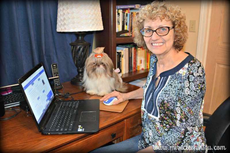 Janice at her work-at-home desk. Her canine "supervisor" watches her every move. ;-)