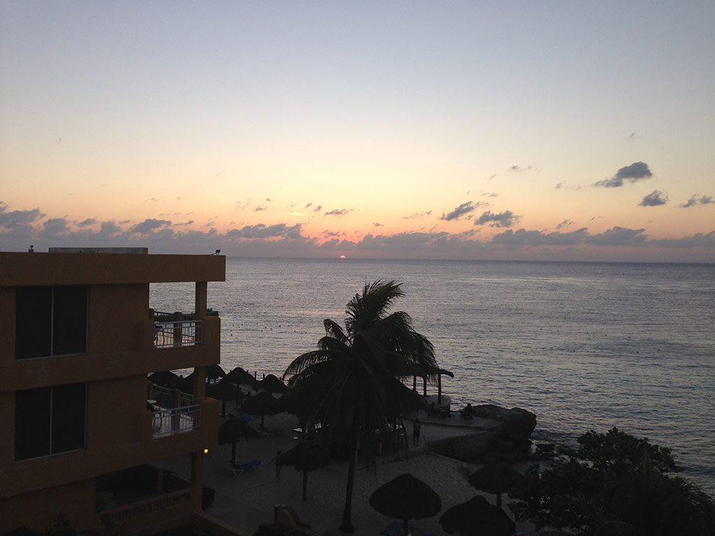 Office with a view: Dan loves to work from the balcony at the Playa Azul Hotel in Cozumel, Mexico