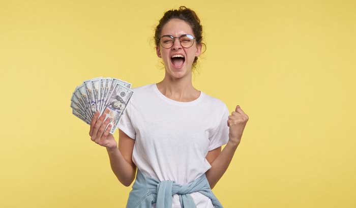 Happy person holding money from selling her website