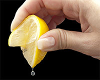 Lemon wedge being squeezed