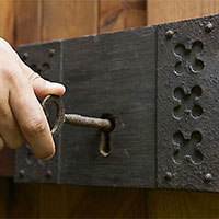 Hand inserting key into lock