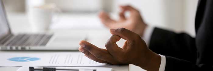 Meditating hands at desk