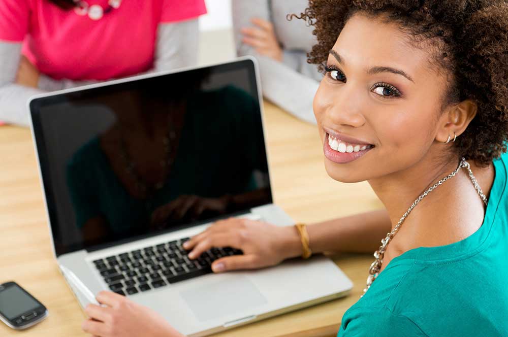 Woman on a laptop working on her side-hustle