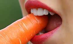 woman eating a carrot