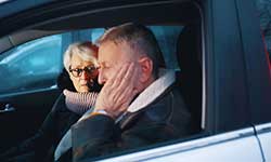 husband and wife in a car talking about being bored in retirement