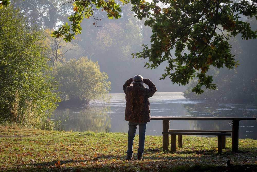 Man standing near lake